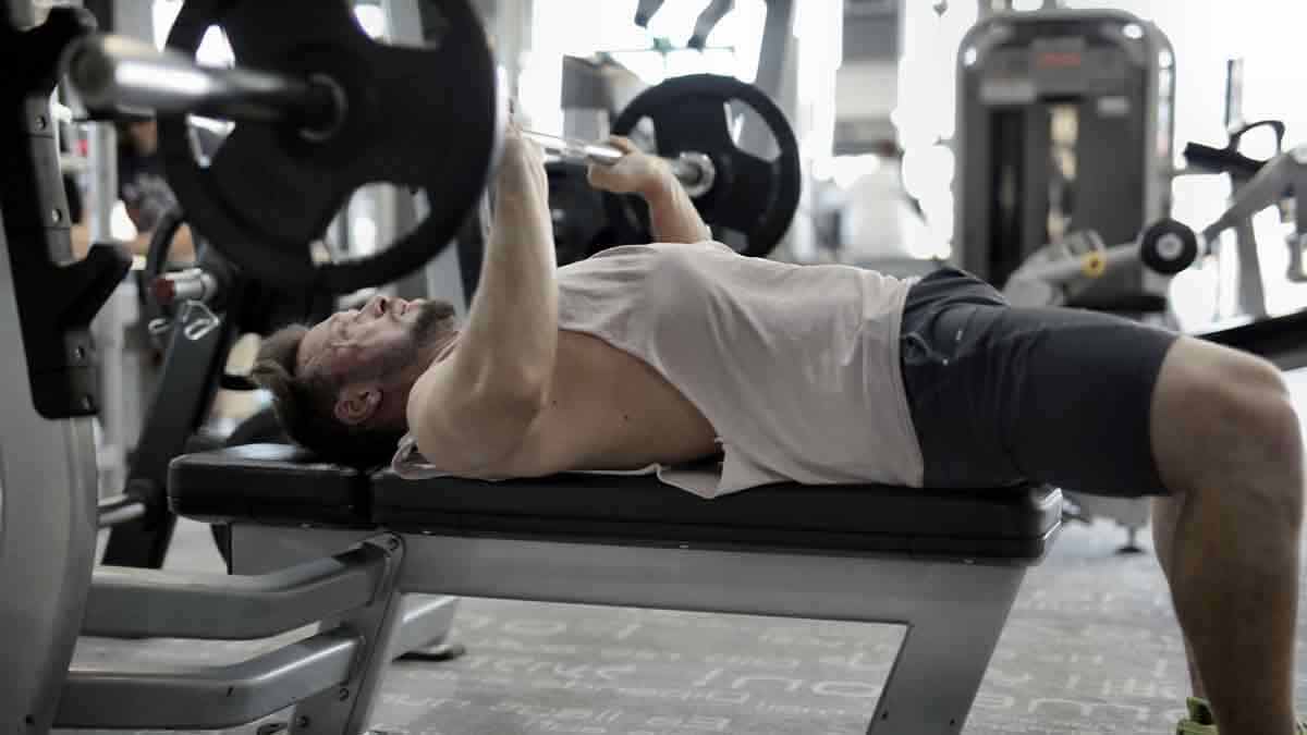 Levantar la barra con peso para trabajar los pectorales