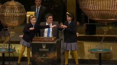 Dos niñas del colegio de San Ildefonso cantando la Lotería de Navidad.