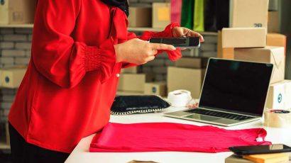 Una persona haciendo una foto con el móvil a una prenda de ropa.