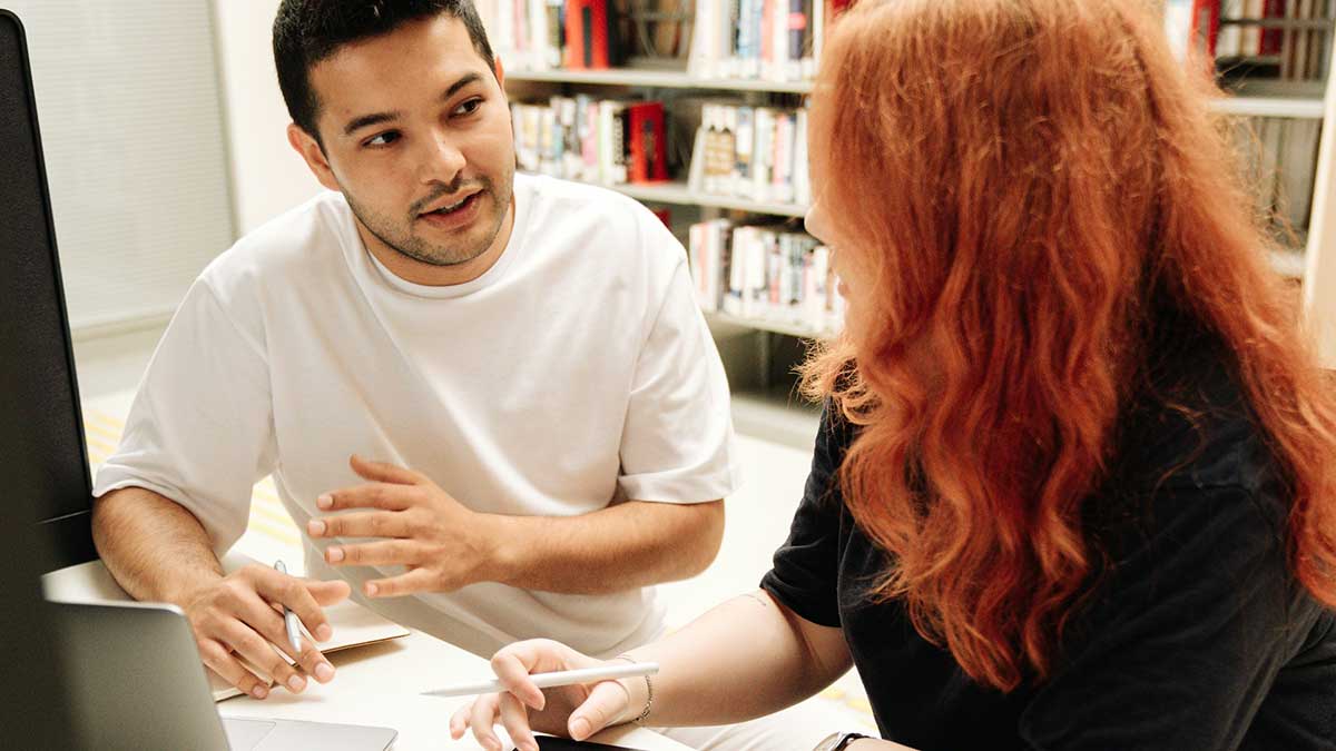 Unos estudiantes universitarios, beneficiarios de la beca MEC, estudina en una biblioteca.